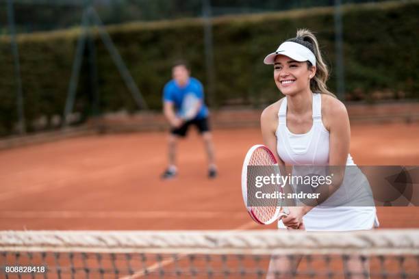 couple playing doubles in a tennis match - woman tennis stock pictures, royalty-free photos & images