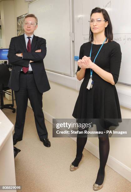 Education Secretary Michael Gove takes part in a science class experiment to study endothermic and exothermic chemical reactions during his visit to...
