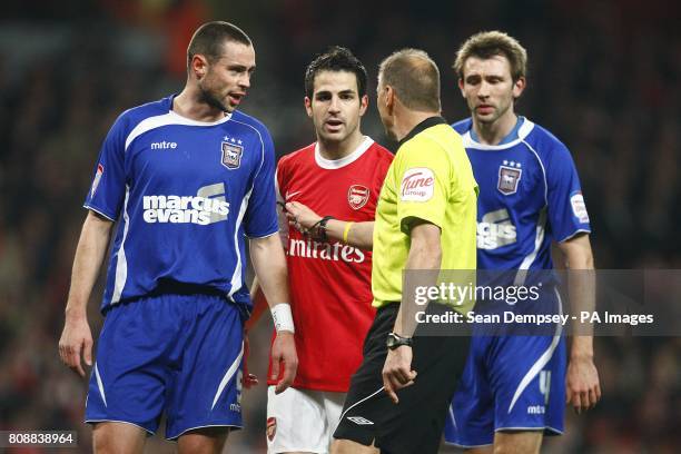 Referee Mark Halsey steps in to calm Ipswich Town's Damien Delaney and Arsenal's Francesc Fabregas