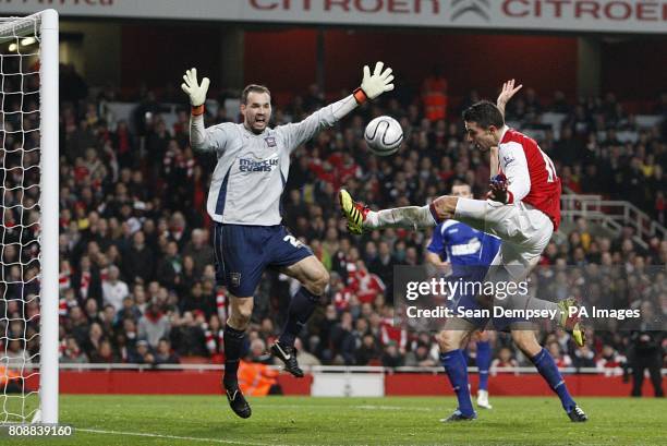 Arsenal's Robin van Persie has a shot on goal