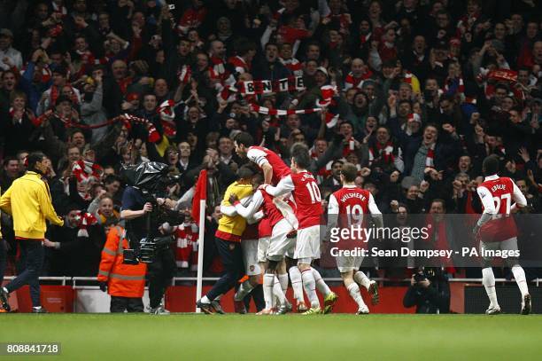 Arsenal's Laurent Koscielny is mobbed by team-mates after scoring their second goal of the game