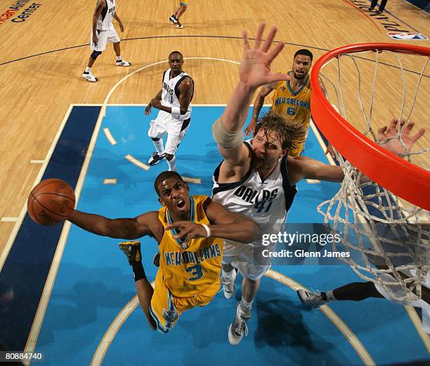 Chris Paul of the New Orleans Hornets goes up for the layup against Dirk Nowitzki of the Dallas Mavericks in Game Four of the Western Conference...