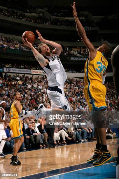 Dirk Nowitzki of the Dallas Mavericks goes up for the layup against David West of the New Orleans Hornets in Game Four of the Western Conference...