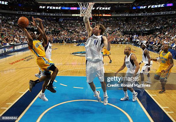 Forward Chris Paul of the New Orleans Hornets takes a shot against Dirk Nowitzki of the Dallas Mavericks in Game Four of the Western Conference...