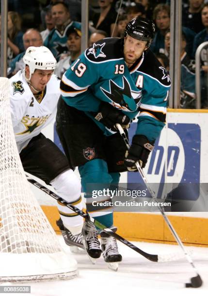 Joe Thornton of the San Jose Sharks attempts to center the puck under pressure from Nicklas Grossman of the Dallas Stars during Game 2 of the Western...