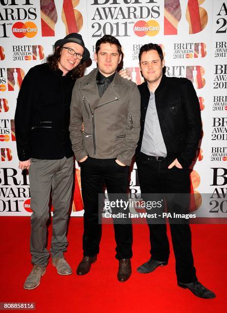 Greg Churchouse, Roy Stride and Peter Ellard of Scouting for Girls arriving for the 2011 Brit Awards at the O2 Arena, London.