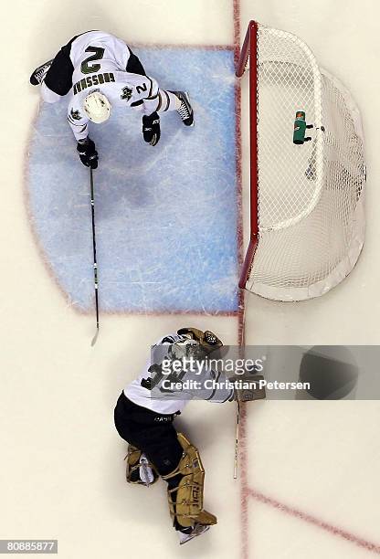 Goaltender Marty Turco of the Dallas Stars makes a stick save as Nicklas Grossman reaches in during game two of the Western Conference Semifinals of...