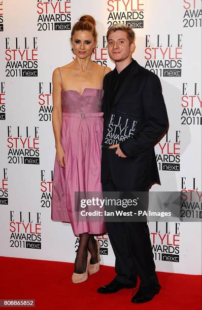 Dominic Jones with his award for Best Jewellery Designer and Laura Bailey during the Grand Connaught Rooms, Great Queen Street, London.