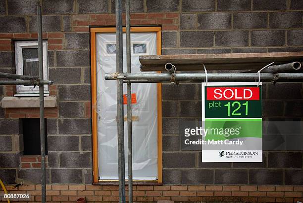 Sold sign is displayed outside a house being constructed on a housing estate by developer and housebuilder Persimmon on April 27 2008 in Bath,...