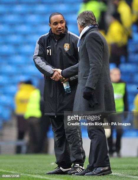 Notts County manager Paul Ince shakes hands with Manchester City manager Roberto Mancini on the touchline after the final whistle