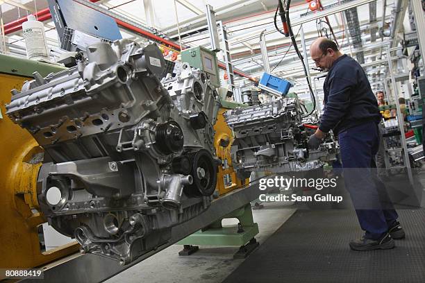 Worker assembles an engine at the Daimler car and truck engine factory on April 28, 2008 in Berlin, Germany. The German government recently lowered...