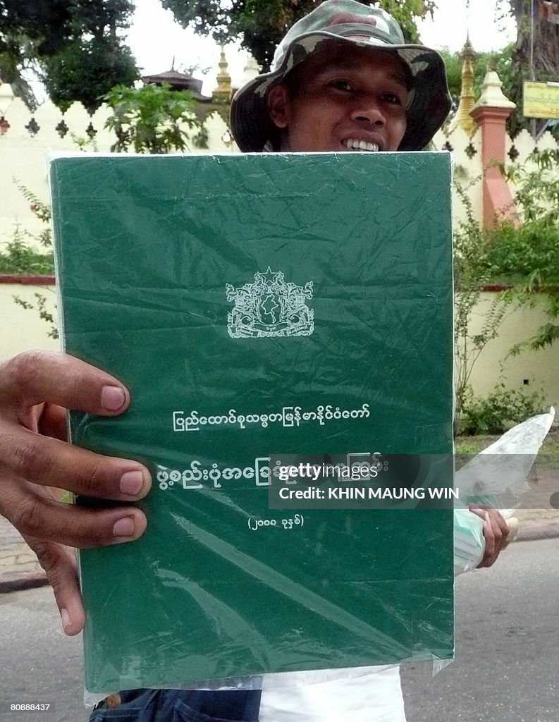 A hawker sells copies of countries new c
