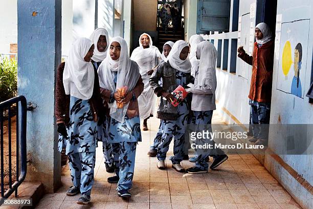 Sudanese school girls wearing a military style camouflage uniform are seen during a break in between classes on January 16, 2007 in Khartoum, Sudan....
