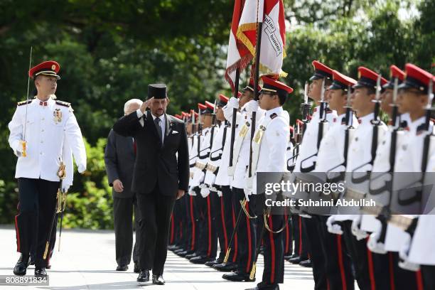 Sultan of Brunei Hassanal Bolkiah inspects the guard of honour, accompanied by Singapore President, Tony Tan Keng Yam during the welcome ceremony at...