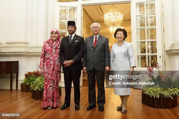 Sultan of Brunei Hassanal Bolkiah and wife, Queen of Brunei Hajah Saleha and Singapore President Tony Tan Keng Yam and wife, Mary Chee Bee Kiang pose...