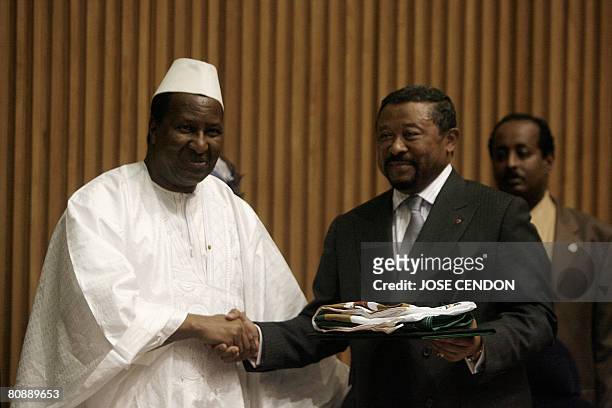 The outgoing Chairperson of the African Union Commission Alpha Omar Konare hands over the Symbols of the Union to the incoming Chairperson of the...