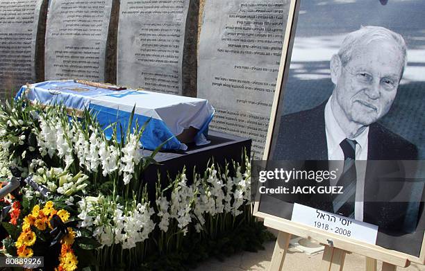 Flowers surround the coffin of Yossi Harel draped in the Israeli flag during a memorial ceremony in Tel Aviv on April 28, 2008. Harel, the captain of...