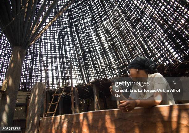 Woman drinking a coffee under a Gurage traditional roof without thatch in renovation, Gurage Zone, Butajira, Ethiopia on June 18, 2017 in Butajira,...