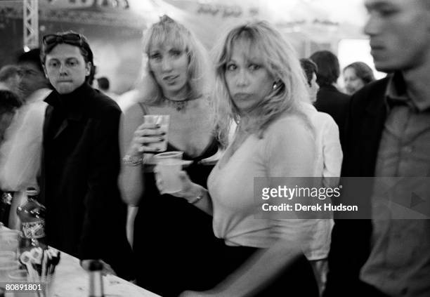 Two women at a drinks bar at the Canal+ party tent during Cannes Film Festival, on May 20, 1998 in Cannes, France.