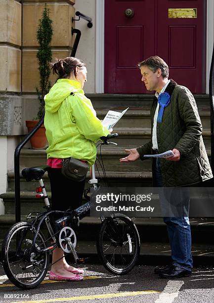 Mark Coote, Conservative Party parliamentary candidate for Cheltenham, chats to voter as he delivers leaflets as part of his party's canvassing...