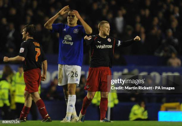 Reading's goalscorer Matt Mills celebrates as Everton's Jack Rodwell shows is dejection at the end of the game during the FA Cup Fifth Round match at...