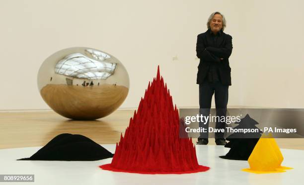 Former Turner prize winning artist Anish Kapoor stands alongside a piece of his work called White Sand, Red Millett, Many Flower 1982, which is on...