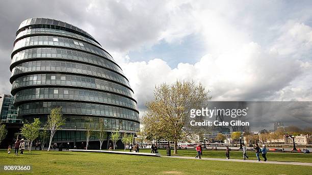 City workers and tourists pass City Hall on April 28, 2008 in London, England. City Hall is the headquarters for the Mayor of London, a title due to...