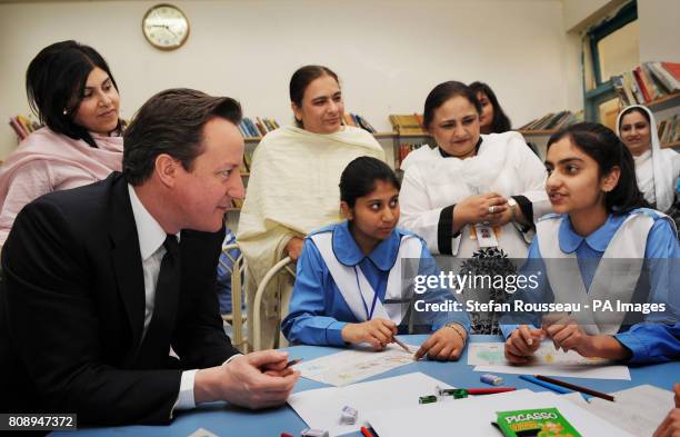 Prime Minister David Cameron meets pupils at Islamabad College for Girls in the Pakistan capital today where he later met with his Pakistani...