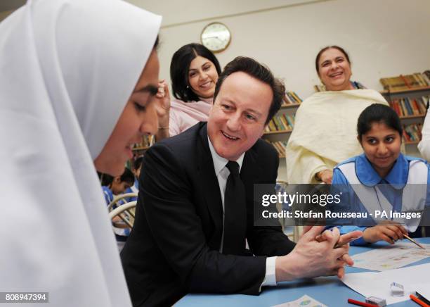 Prime Minister David Cameron meets pupils at Islamabad College for Girls in the Pakistan capital today where he later met with his Pakistani...