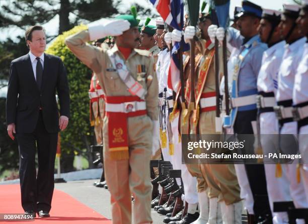 Prime Minister David Cameron inspects a guard of honour at the Pakistan Prime Minister Yousuf Raza Gilani's residence in Islamabad where the two held...