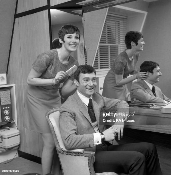 Canadian actress Beverly Adams combs the hair of her fiance, hair stylist Vidal Sassoon, at his Mayfair home. The couple plan to marry in March .