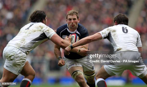 Scotland's John Barclay is tackled by England's Alex Corbisiero and Tom Wood