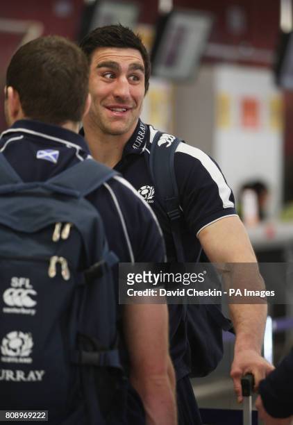 Scotland's Kelly Brown arrives at Edinburgh Airport as the team prepare to depart for London.