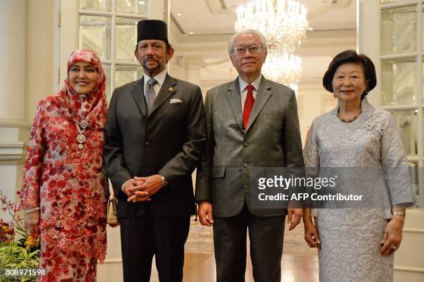 Brunei Sultan Hassanal Bolkiah and Queen Consort Pengiran Anak Saleha poses with Singapore's President Tony Tan Keng Yam and his wife Mary Tan at the...