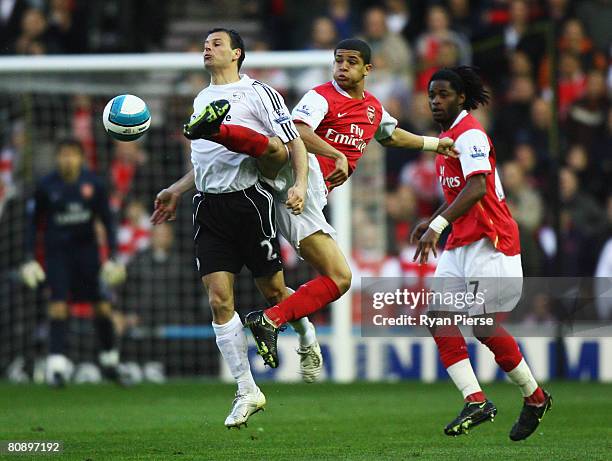 Denilson and Alexandre Song Billong of Arsenal challenge Marc Edworthy of Derby County during the Barclays Premier League match between Derby County...