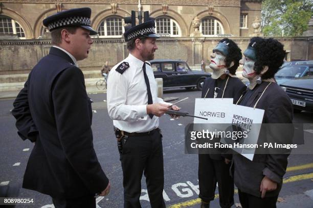 Friends of the Earth protesters, dressed in Frankenstein outfits, are told to move on by police during a demonstration against government plans to...