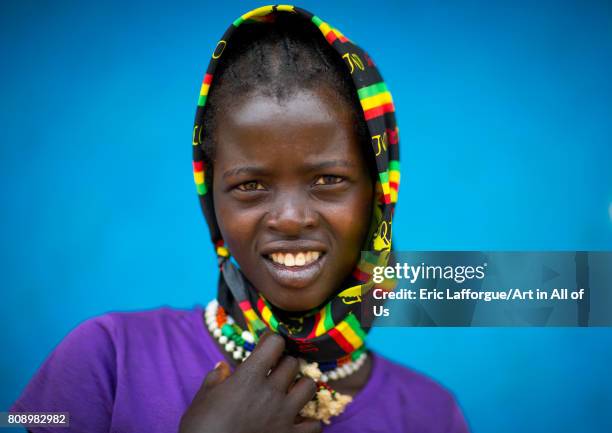 Portrait of a Bana tribe girl in front of a blue wall, Omo valley, Key Afer, Ethiopia on June 8, 2017 in Key Afer, Ethiopia.