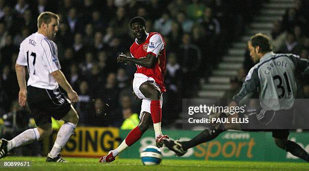 Arsenal's Togolese forward Emmanuel Adebayor scores past Derby County's English goalkeeper Roy Carroll during their English Premier League football...