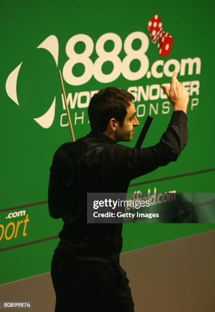 Ronnie O'Sullivan of England celebrates making a break of 147, his record breaking ninth in professional competition, against Mark Williams of Wales...
