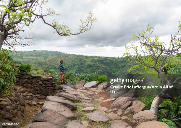 Konwo woman on a paved road in a traditional village, Omo valley, Konso, Ethiopia on June 14, 2017 in Konso, Ethiopia.