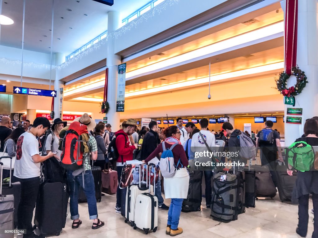 Crowds of passengers in departure area of Cancun International Airport, Mexico