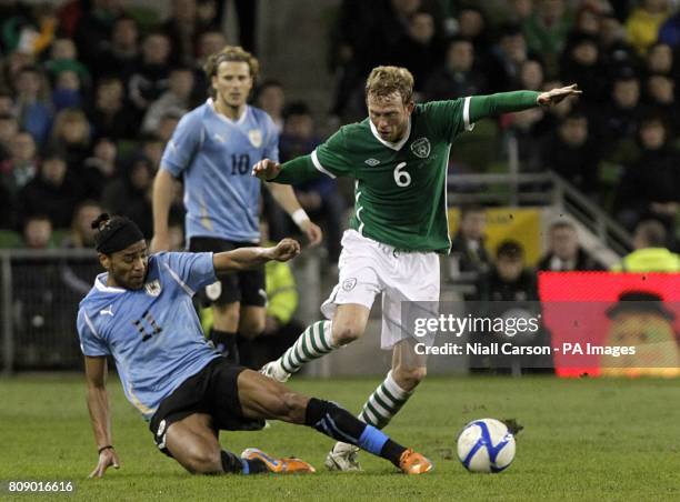 Republic of Ireland's Paul Green and Uruguay's Alvaro Pereira battle for the ball.