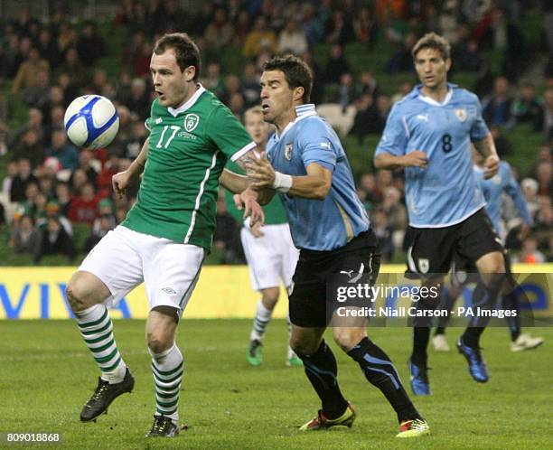 Uruguay's Andres Scotti and Republic of Ireland's Anthony Stokes battle for the ball.