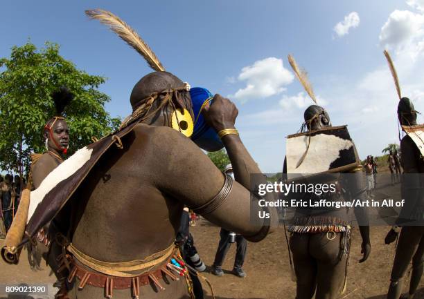 Bodi tribe fat men drinking milk during the Kael ceremony, Omo valley, Hana Mursi, Ethiopia on June 4, 2017 in Hana Mursi, Ethiopia.