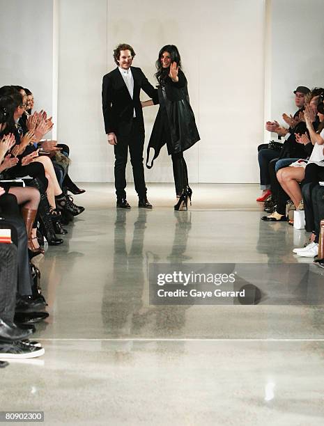 Designers Camilla Freeman-Topper and Marc Freeman appear on the stage following their Camilla & Marc catwalk show on the second day of the Rosemount...