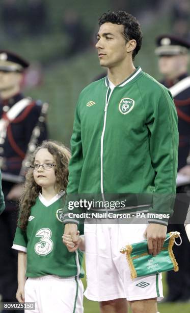 Republic of Ireland's Stephen Kelly with a mascot before the match.