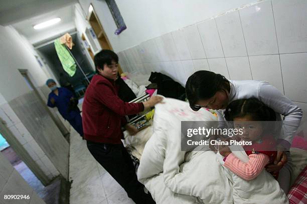 Parents attend to children who suffer from the hand, foot and mouth disease caused by the enterovirus 71 as they undergo treatment in a hospital on...