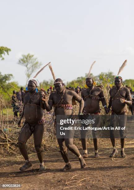 Bodi tribe fat men running during Kael ceremony, Omo valley, Hana Mursi, Ethiopia on June 4, 2017 in Hana Mursi, Ethiopia.