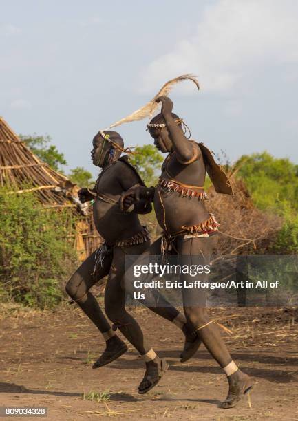 Bodi tribe fat men running during Kael ceremony, Omo valley, Hana Mursi, Ethiopia on June 4, 2017 in Hana Mursi, Ethiopia.