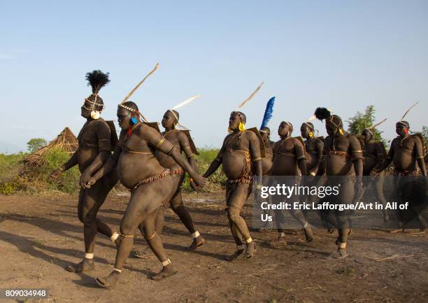 Bodi tribe fat men running during Kael ceremony, Omo valley, Hana Mursi, Ethiopia on June 4, 2017 in Hana Mursi, Ethiopia.